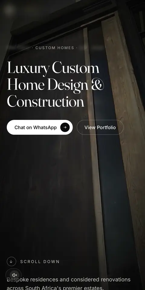 The studio's home page on a phone: luxury custom home design and construction, with WhatsApp and portfolio buttons